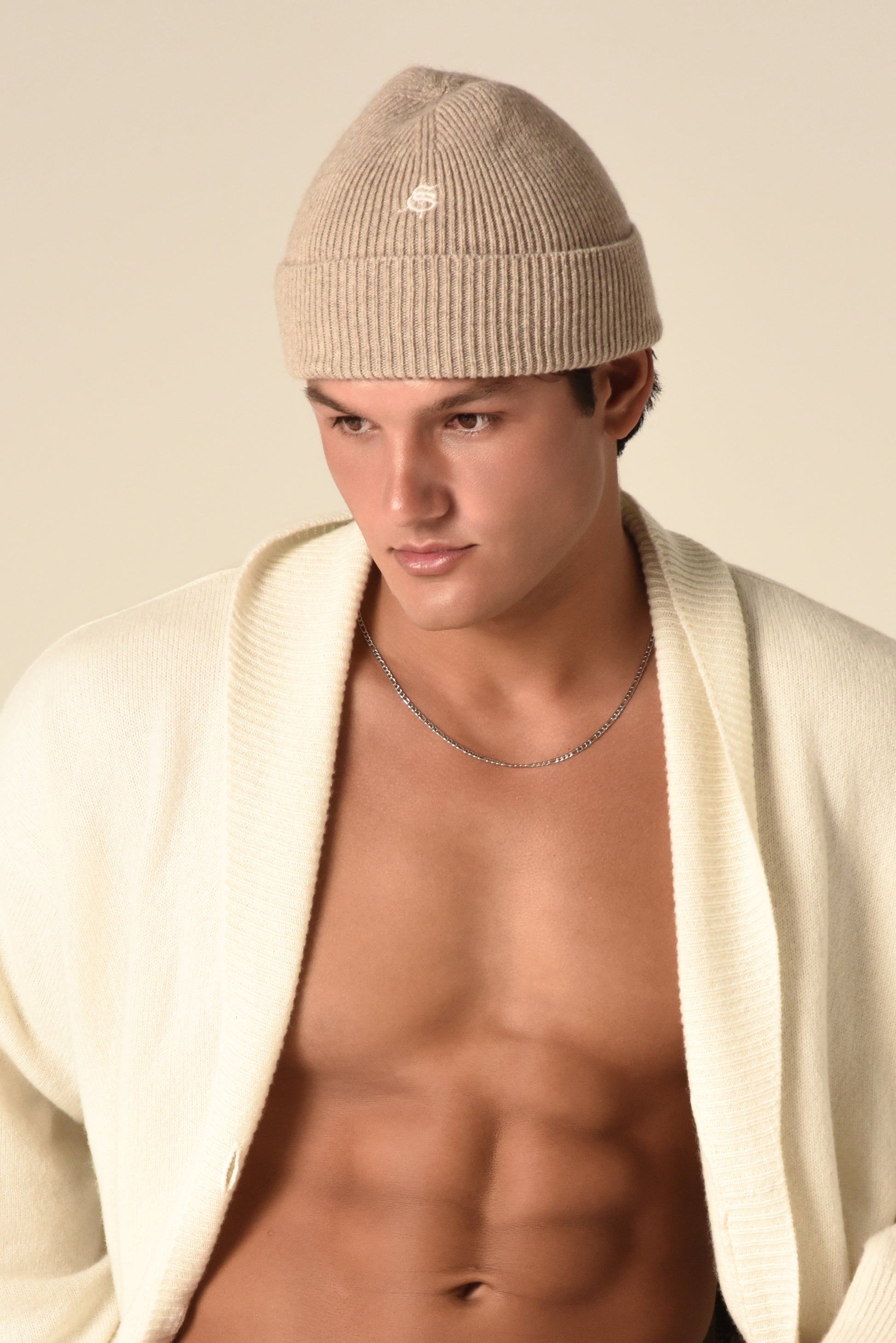 Man wearing a nude beanie with embroidery detail