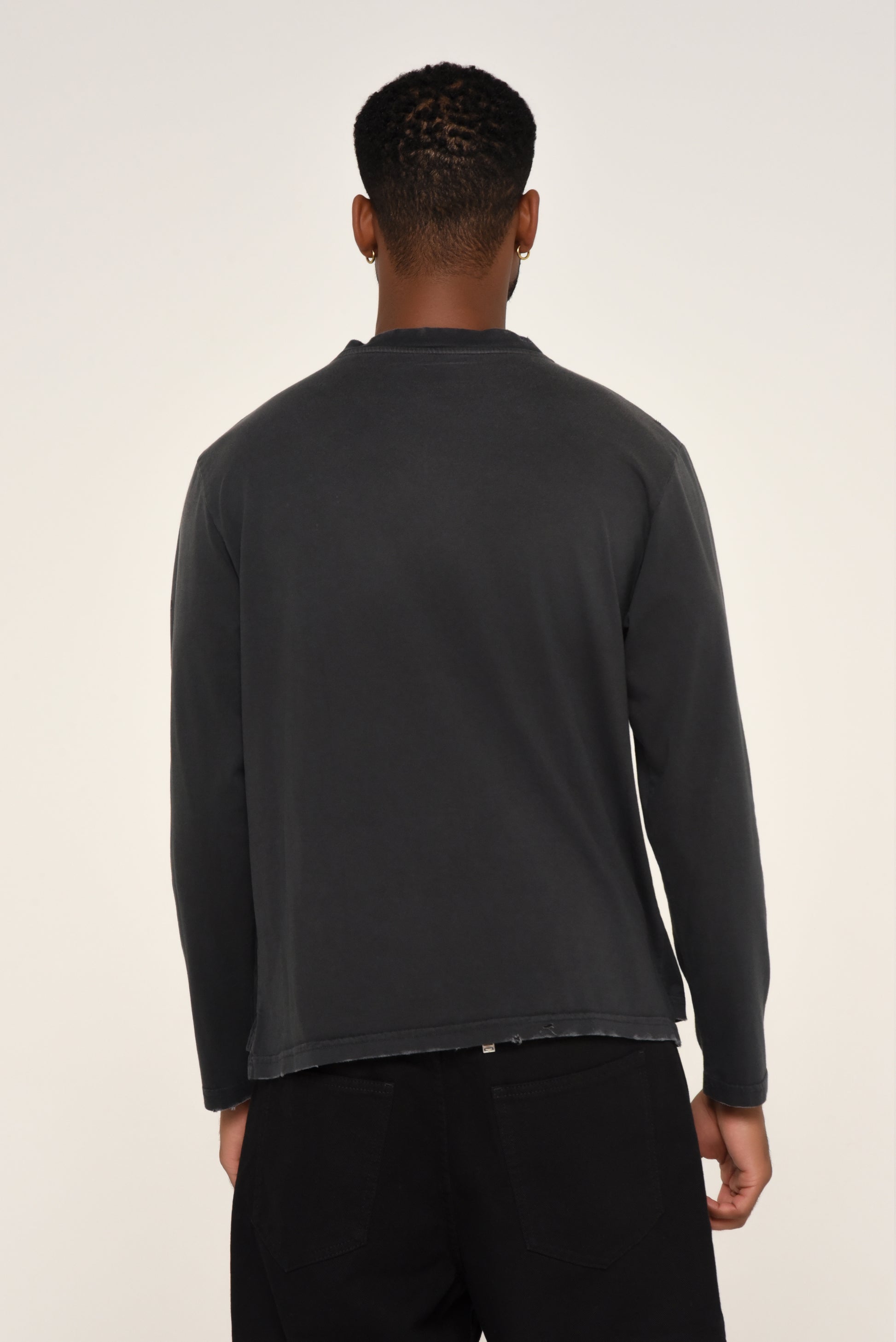 back view of man wearing a black long sleeve shirt